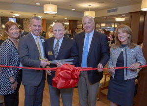 A ribbon-cutting ceremony at The Commons on March 29 featured (left to right) Stephanie Handelson, president and COO of Benchmark Senior Living; Benchmark executive director Chris Golen, Dr. Laurie Tolman, a resident of The Commons; Tom Grape, founder and CEO of Benchmark; and Lt. Governor Karyn Polito. See more photos below.